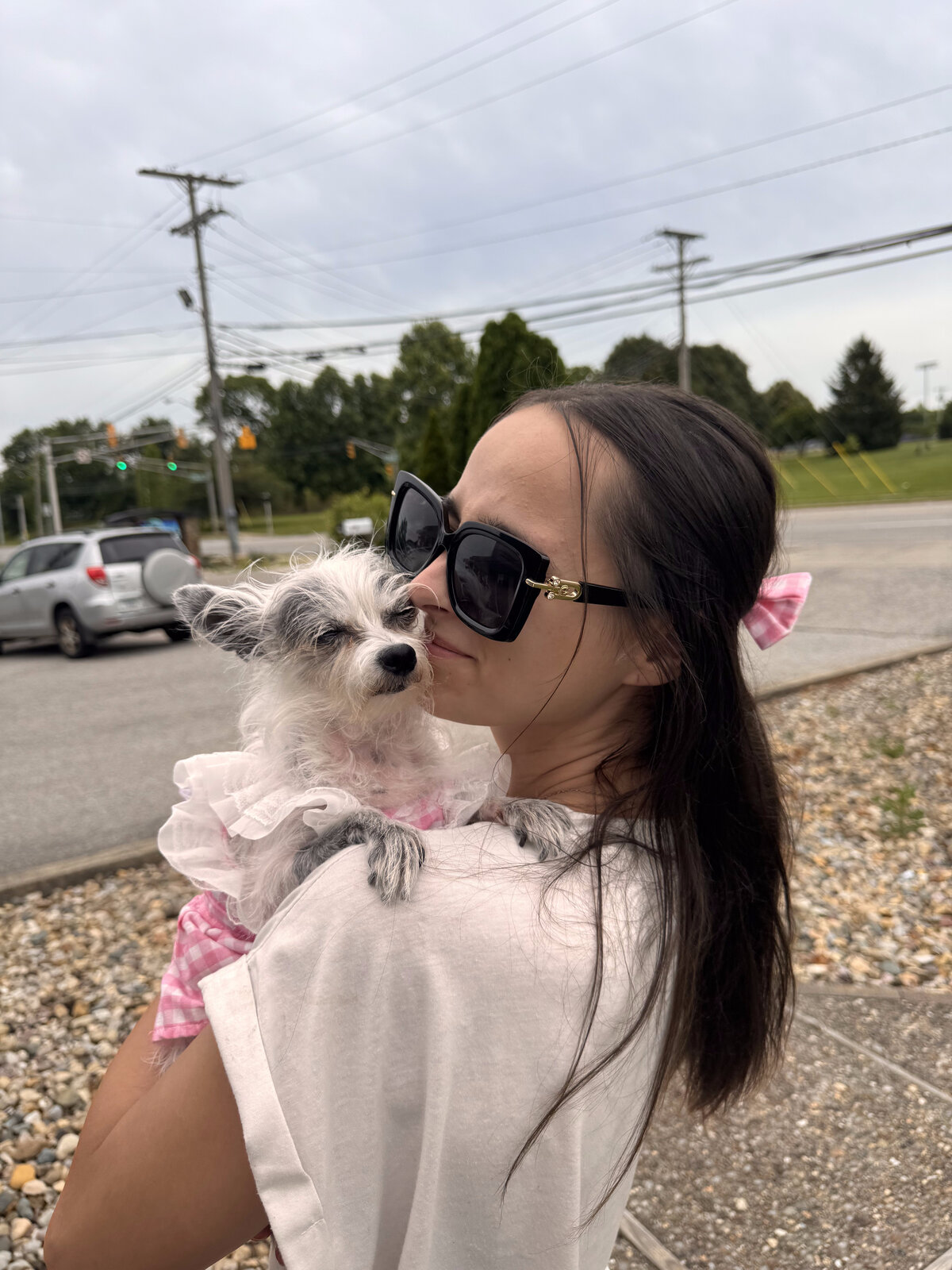 Anna holding her dog affectionately